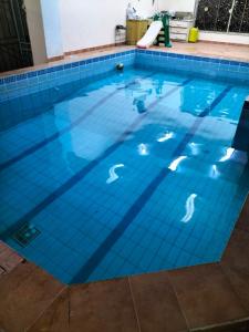 a large swimming pool with blue tiles on the floor at Villa Marmara in Medina