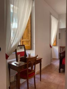 ローマにあるCozy Apartment Spagnaのデスク、テーブル、窓が備わる客室です。
