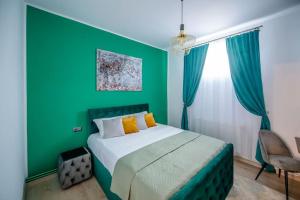 Dormitorio verde con cama y pared verde en Casa Habitat, en Timisoara