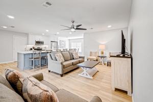 a living room with a couch and a kitchen at Lagoon Retreat in Pensacola