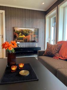 a living room with a couch and a table with candles at Bualie Golsfjellet in Gol