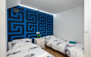 Łóżko lub łóżka w pokoju w obiekcie Apartament Akademicka Jacuzzi Centrum