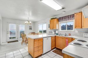 a kitchen with wooden cabinets and white appliances at Marina Retreat in Garden City