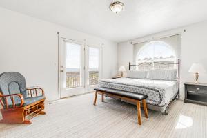 a bedroom with a bed and a chair and windows at Marina Retreat in Garden City +28 photos