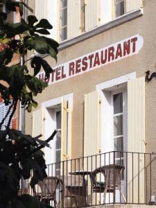 a sign for a hotel restaurant on the side of a building at la dame jeanne in Cucuron