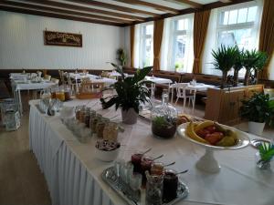 a long table with food on it in a restaurant at Bed and Breakfast Am Knittenberg in Winterberg