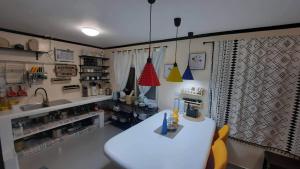 a kitchen with a white table and a sink at Pretty flat with full AC 