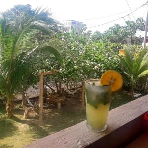 a drink sitting on a ledge with a drink at OCEAN SURF in Mompiche