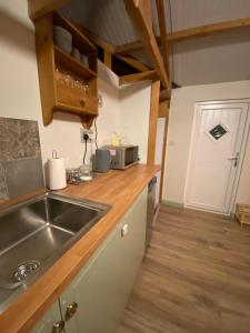 a kitchen with a sink and a counter top at The Shack plus Camping in Llandinam