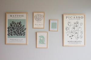 a wall with four framed drawings of plants at High End Cozy Apt at CENTRAL RECOLETA -Amazing View- 12H in Buenos Aires