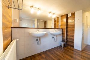 a bathroom with two sinks and a mirror at Holiday house Vedle in Desná +25 photos