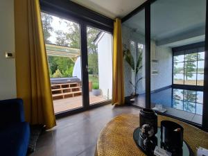 a living room with a table and a large window at Loftconcept57 in Kerprich-aux-Bois