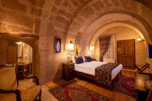 a bedroom with a king sized bed in a castle at Portal Cappadocia Hotel in Ortahisar
