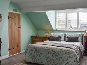a bedroom with a bed and a window at Bay Cottage in Cayton