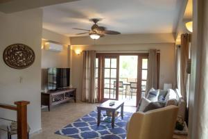a living room with a couch and a table at Placencia Pointe Townhomes #7 in Placencia