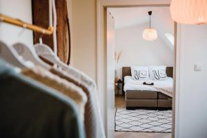 a view of a bedroom with a bed and a couch at Monumentale stolpboerderij voorzien van alle gemakken van nu! in Twisk