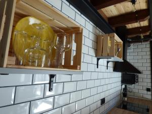 a kitchen with wine glasses in a cabinet at Casa galana 