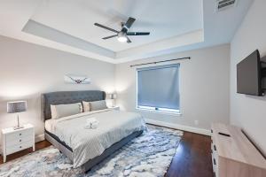 a bedroom with a bed and a ceiling fan at 9 Minutes to Downtown Dallas - 1000mbps - King Suite - 58 in TV - Games in Dallas