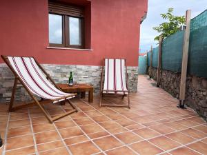 two chairs and a table on a patio at La Casina in Oviñana
