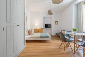 a bedroom with a bed and a table and chairs at Apartamentos Fucar in Madrid