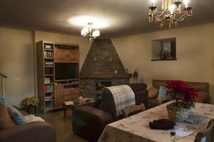 a living room with a table and a fireplace at Casa Gloria in Moncó