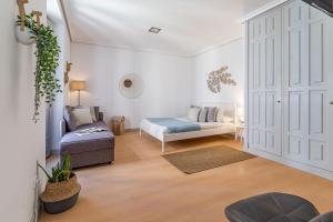 a living room with a bed and a couch at Apartamentos Fucar in Madrid