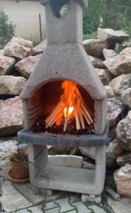 a stone oven with a fire inside of it at Elitegasthaus Moieciu A in Moieciu de Jos