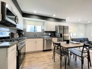 a large kitchen with a table and chairs in it at 4BR Townhouse in KoreaTown in Los Angeles