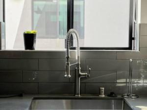 a kitchen sink with a faucet next to a window at 4BR Townhouse in KoreaTown in Los Angeles