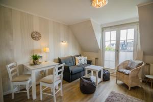 a living room with a couch and a table at Westbrise App 7 in Wenningstedt