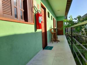 a corridor of a house with a red fire hydrant at Pousada Reis Guarujá in Guarujá