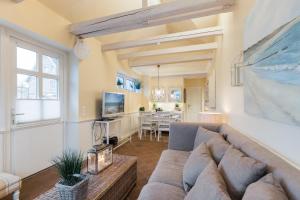 a living room with a couch and a table at App Wellness in Westerland (Sylt)