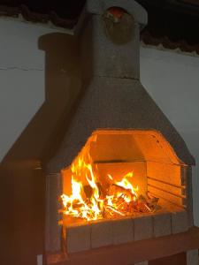 a brick oven with a fire in it at Ninna House in Villa San Sebastiano