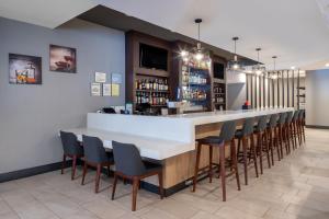 a bar in a restaurant with chairs around it at Holiday Inn Poughkeepsie, an IHG Hotel in Poughkeepsie