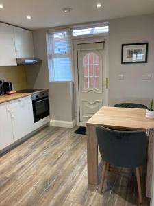 a kitchen with a table and a door in a room at Estuary View Apartment in Kilrush