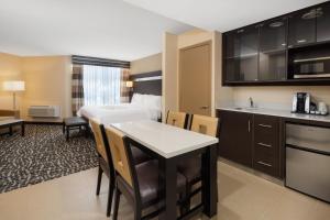 a hotel room with a kitchen and a bedroom at Holiday Inn Poughkeepsie, an IHG Hotel in Poughkeepsie
