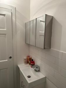 a white bathroom with a sink and a mirror at Amazing Getaways - The Place for You with Free Parking in Aberdeen