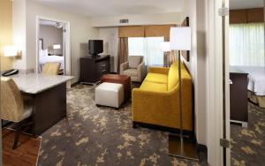 a hotel room with a bed and a living room at Trellis Lake Pointe in Charlotte
