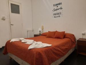 a bedroom with a bed with towels on it at Hotel Astro in Mar del Plata