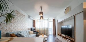 Pastelle Apartment with own parking place في بودابست: غرفة معيشة مع أريكة وتلفزيون