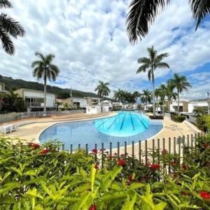 una gran piscina con palmeras y una valla en Ciudadela del sol premium, en San Jerónimo