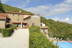 una vista exterior de una casa y una piscina en Agriturismo Poggio de Papi, en Cantagrillo