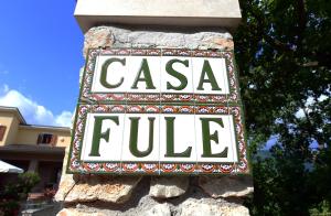 a sign that reads casa fuele on a stone wall at Affittacamere Fulé in Fontecchio