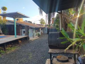 a house with a bench and an umbrella at La Cascada in Posadas