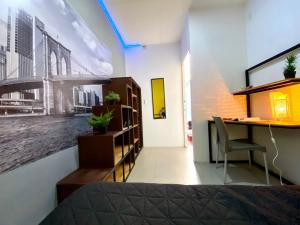 a bedroom with a desk and a deskablish at ROOMIES HOSTEL Parque México in Mexico City