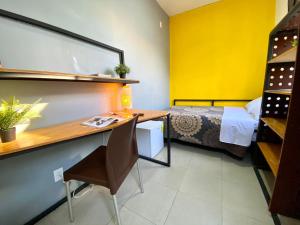 a room with a bed and a desk with a desk at ROOMIES HOSTEL Parque México in Mexico City