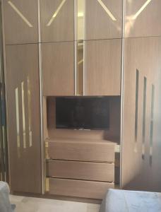 a large wooden cabinet with a television in it at Ap 2ch city centre parking en face Hilton a cote du plage in Tangier