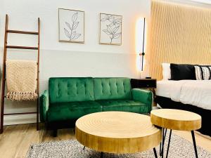 a living room with a green couch and a table at The Westerner - Extended Stay in Amarillo