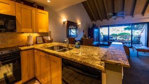 a kitchen with a sink and a counter top at Beautiful 2 Bedroom Oceanview Condo at Maui Kamaole Located at South End of Kihei Adjacent to Wailea Traditional Hawaiian Style in Wailea