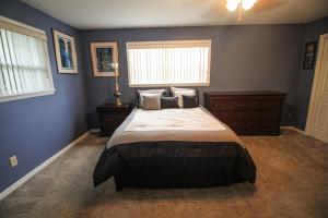 a bedroom with a large bed and a window at 15 Minutes to the Gulf of Mexico! Beautiful home on Lake Rousseau in Dunnellon